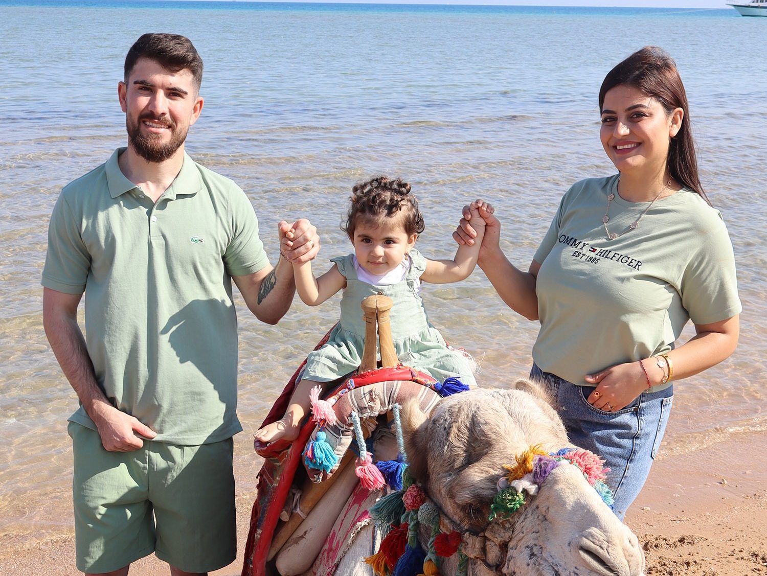 Holidaymakers taking pictures with camels in Egypt