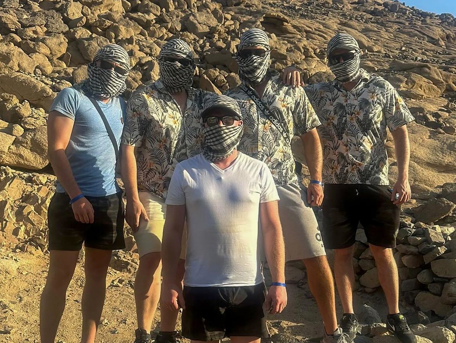 Guests riding moto quads through the desert dunes