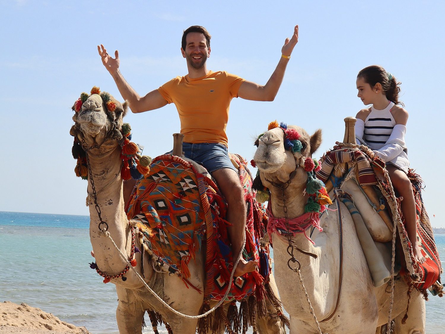Camel riding along Hurghada beach at sunset