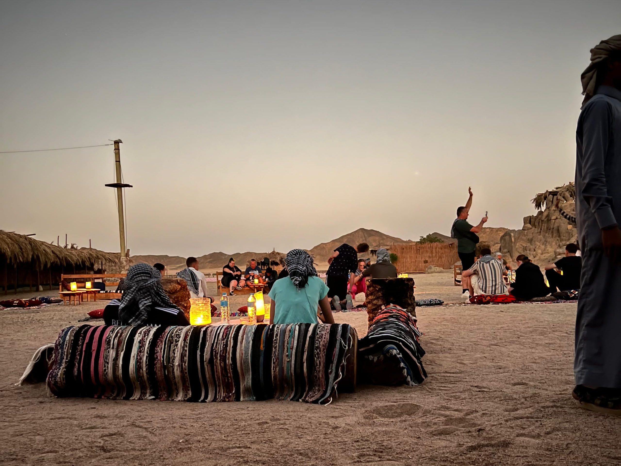 Guests watching the sunset in the Hurghada desert before stargazing