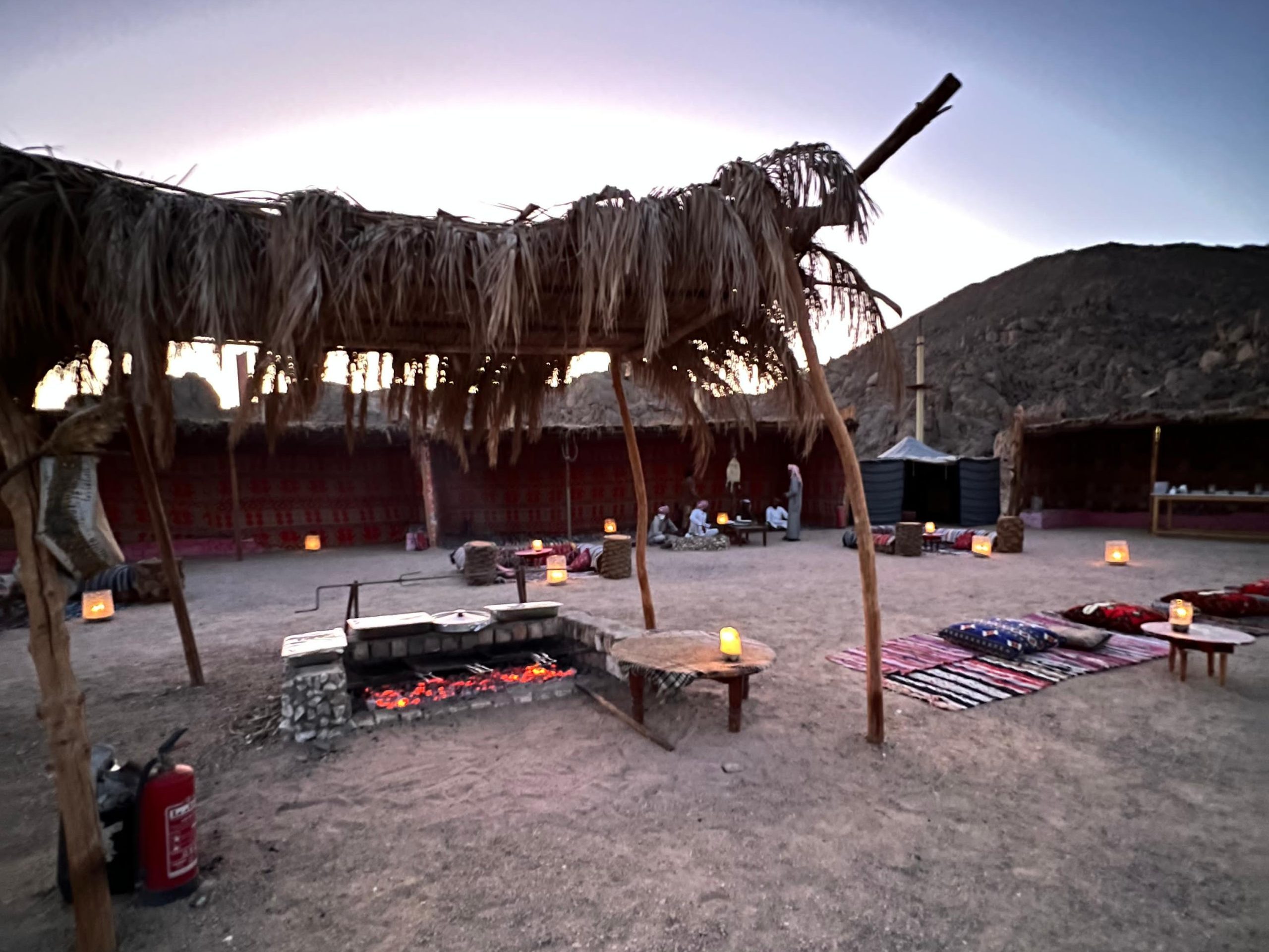 Traditional Bedouin dinner setup with lamps and cushions